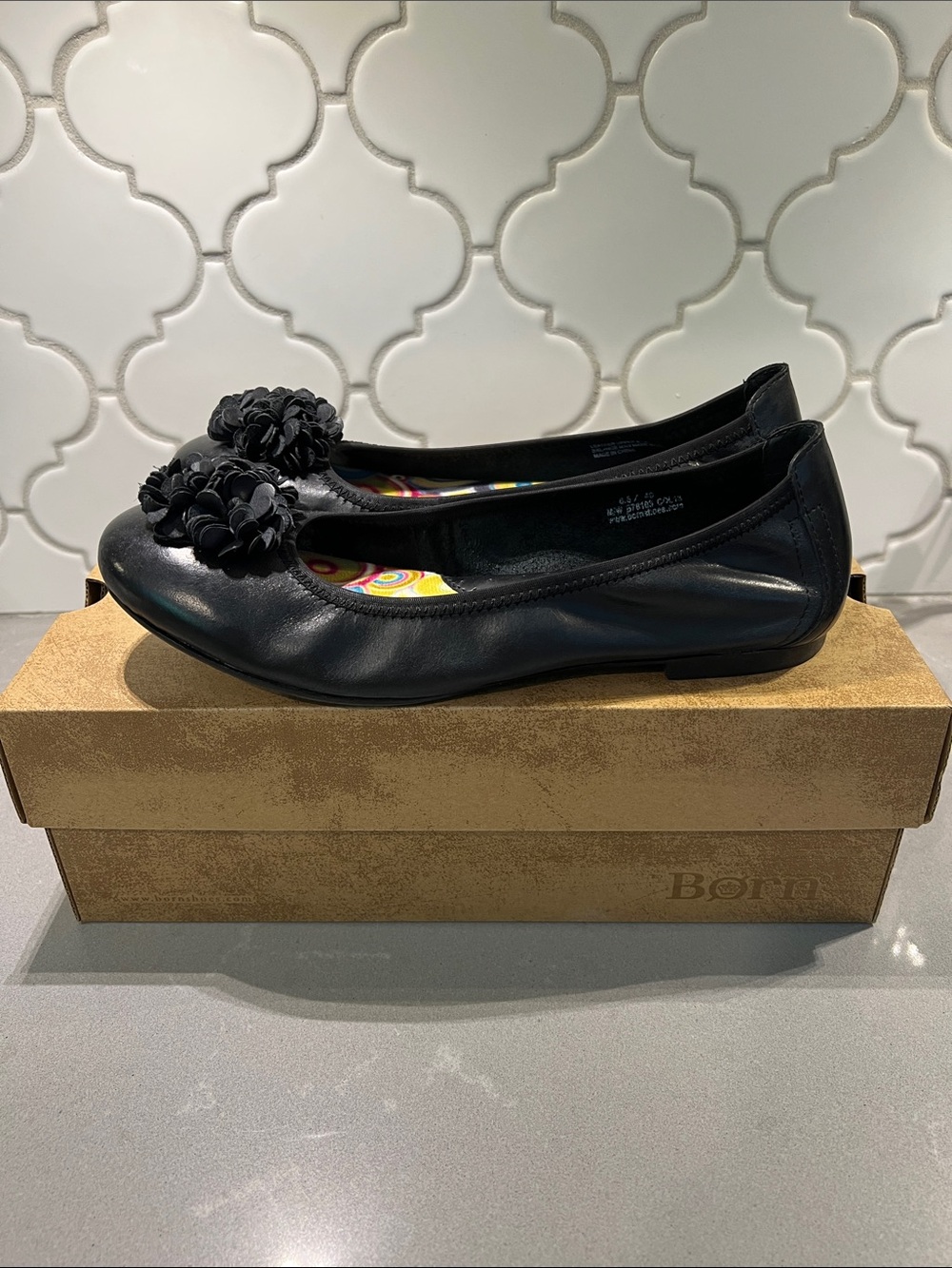 Born Black Leather Ballet Flats with Floral Pom Detail